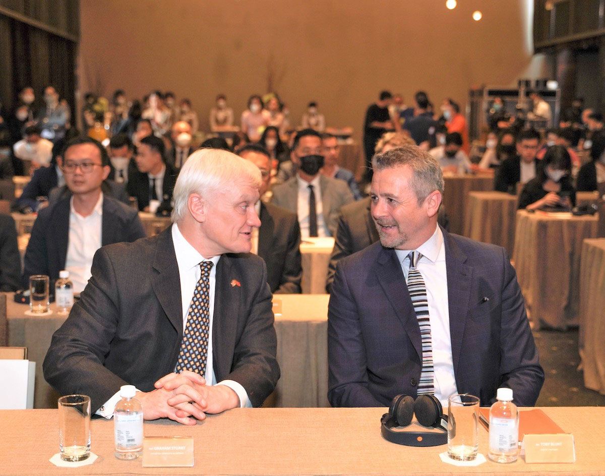 Nghị sĩ Graham Stuart, Đặc phái viên thương mại của Thủ tướng Anh tại Việt Nam, Campuchia và Lào (trái) trò chuyện với ông Toby Blunt, Đối tác cấp cao của Foster + Partners (phải) tại buổi ký kết.